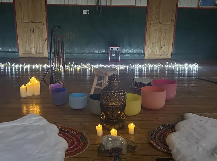 Sound bath space prepared with candles and instruments