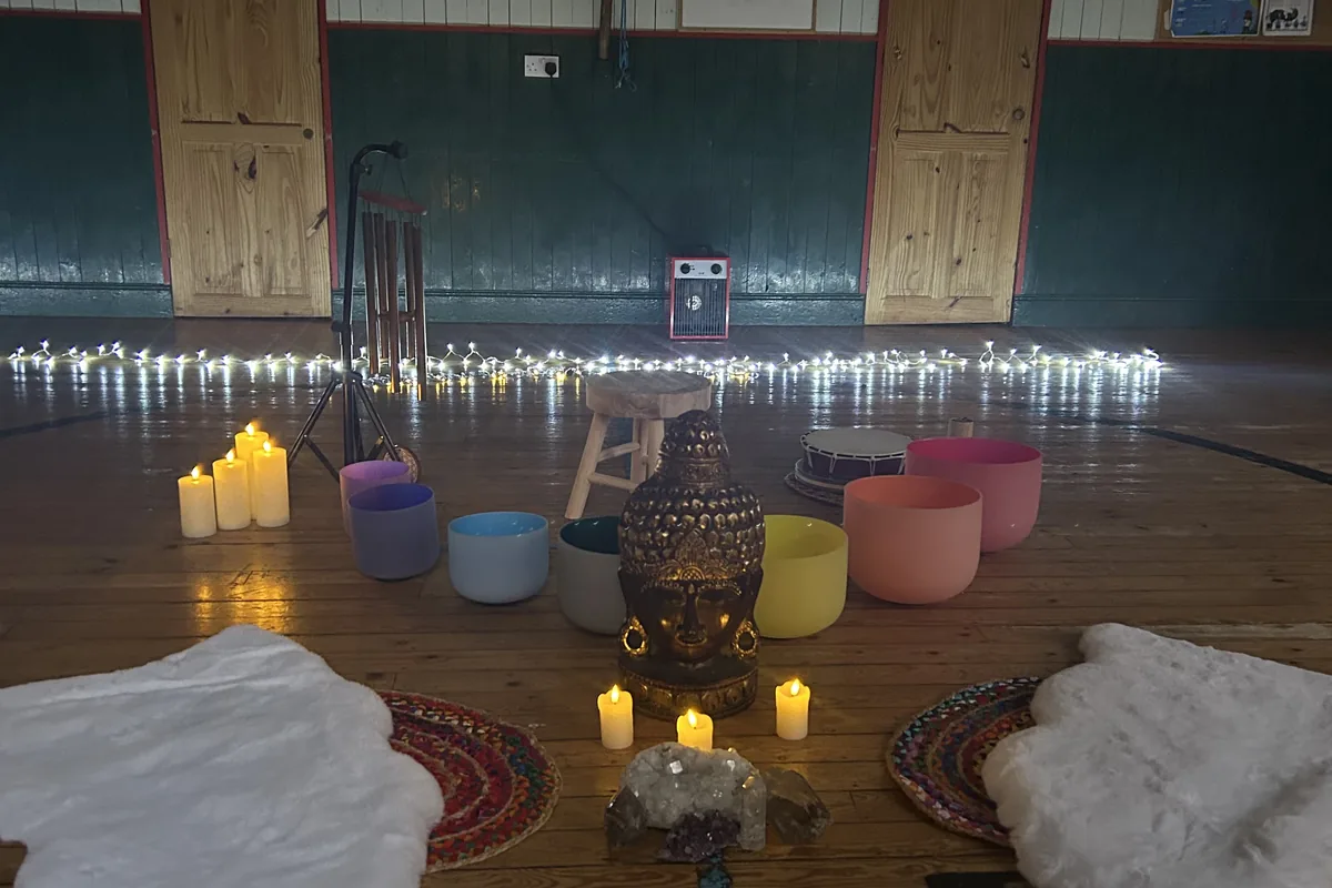 Sound bath setting prepared with candles and instruments